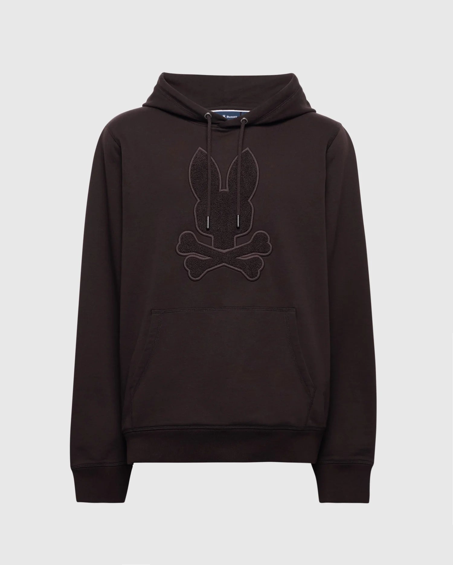 The Psycho Bunny MENS ELDORADO BRUSH BACK HOODIE - B6H234E200 in black features a rabbit head with crossed bones on the front, has a cozy kangaroo pocket, and drawstrings at the neck, set against a plain white background.