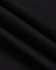 This is a close-up of the black chenille knit fabric from the Psycho Bunny Men's Pacific Chenille Hoodie - B6H930D200, displaying its fine texture. The fabric forms three gentle folds casting shadows, and its soft, slightly stretchy nature suggests it is ideal for garments like hoodies.