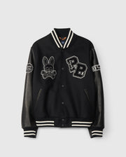 The MENS ROBBINS VARSITY BOMBER JACKET - B6J524Z1OW by Psycho Bunny is a stylish black wool-blend jacket with leather sleeves. It is decorated with embroidered and chenille patches, featuring a skull bunny and "PB" letters, while striped cuffs and collar complete the classic varsity look.