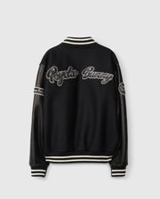 The MENS ROBBINS VARSITY BOMBER JACKET - B6J524Z1OW by Psycho Bunny is a black varsity jacket featuring leather sleeves and a wool-blend body. It is adorned with white embroidered "Psycho Bunny" text on the back, while striped ribbed cuffs and a collar add style, along with chenille patches detailing the sleeves.