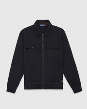 The MENS OROVILLE BOMBER JACKET - B6J712A200 from Psycho Bunny is a black zip-up cotton-poly jacket with a collar and long sleeves. This outerwear includes two buttoned chest pockets and showcases a small orange logo near the hem, set against a plain white background.