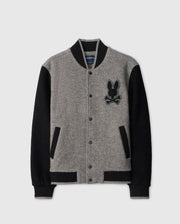 Introducing the Psycho Bunny MENS TOM WOOL BOMBER JACKET - B6J744D200, a sophisticated gray and black bomber crafted from luxurious wool. Featuring a distinctive rabbit and crossbones logo on the chest, this jacket offers black sleeves, a contrasting black collar, and a button-up front with practical pockets—ideal for the fashion-forward gentleman.