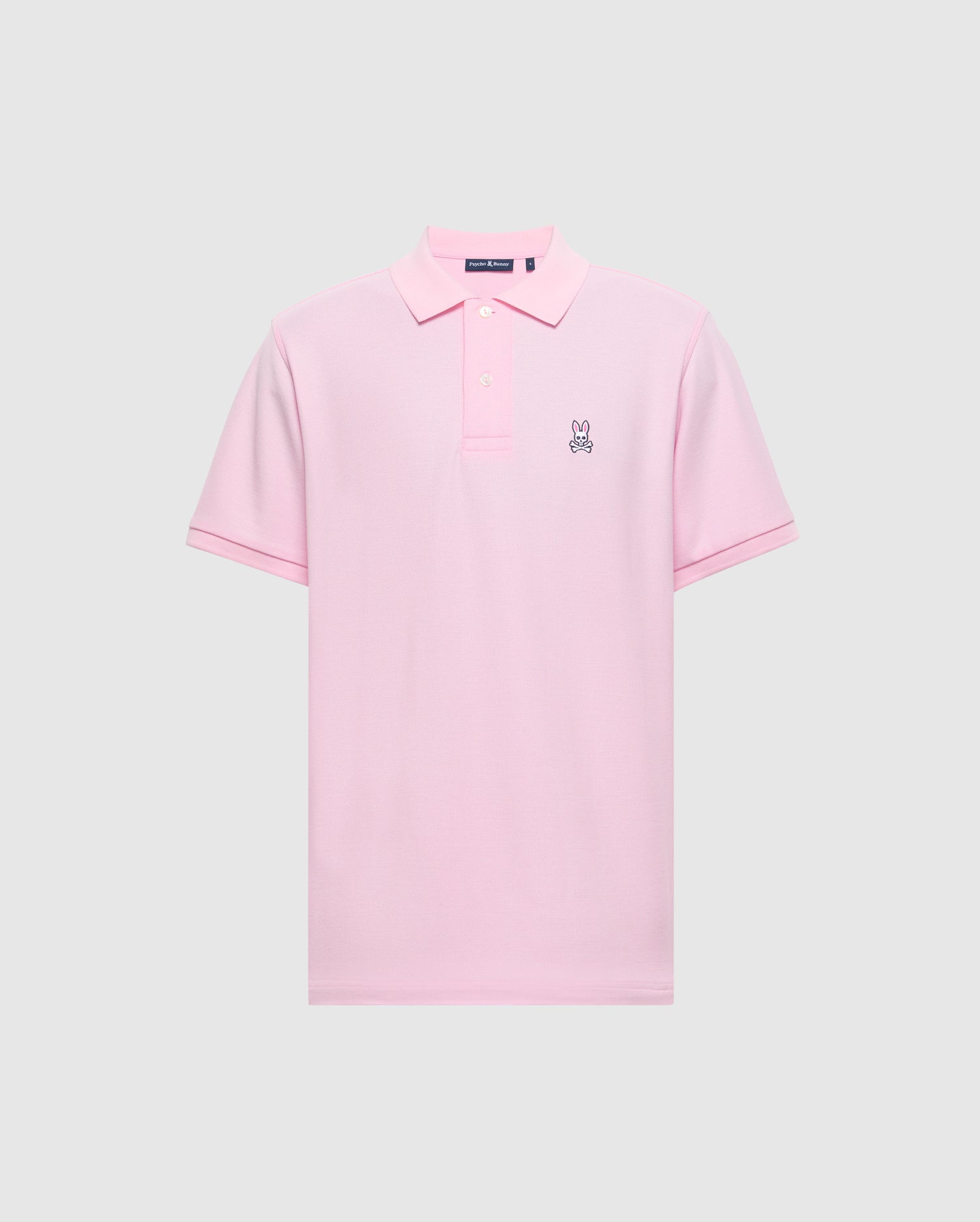 The Psycho Bunny Men's Classic Pique Polo Shirt - B6K001CRPC, is a pink polo made from soft Pima cotton. It features a small embroidered rabbit logo on the left chest, a classic collar, and a button placket against a plain light gray background.