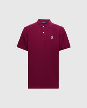 The Psycho Bunny MENS CLASSIC PIQUE POLO SHIRT - B6K001Z1PC is a burgundy short-sleeve crafted from soft Pima cotton, featuring a collar, two buttons, and a small embroidered Bunny logo on the left chest. It is displayed against a plain light gray background.