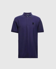 The Psycho Bunny MENS BRANSON PIQUE POLO - B6K108E200 is a premium quality navy blue polo for men, complete with short sleeves and a collar. It boasts a small black insignia on the left chest, providing an elegant contrast to the light gray background.