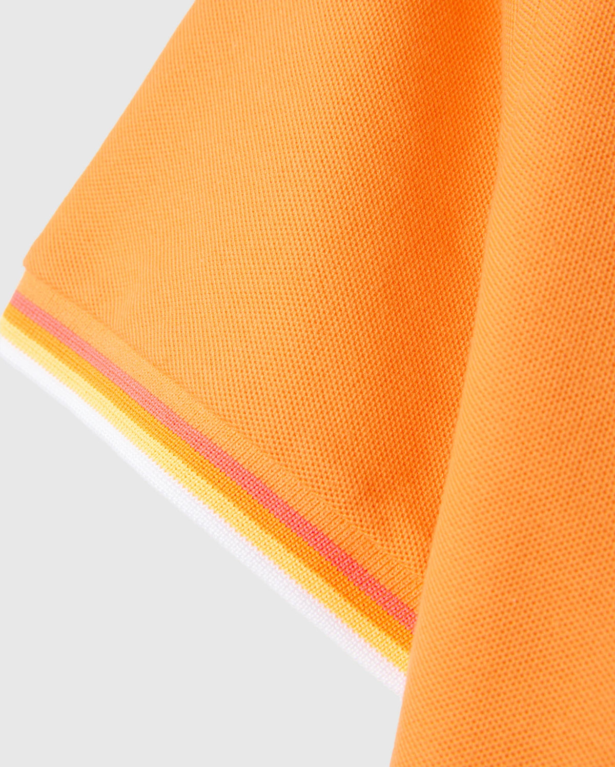 Close-up of the hem of an orange fabric, featuring a textured, woven pattern. The hem is detailed with stripes in yellow, pink, and white at the edge. Reminiscent of a MENS GRANBURY PIQUE POLO - B6K400C200 by Psycho Bunny, the image captures the material and color contrasts beautifully.