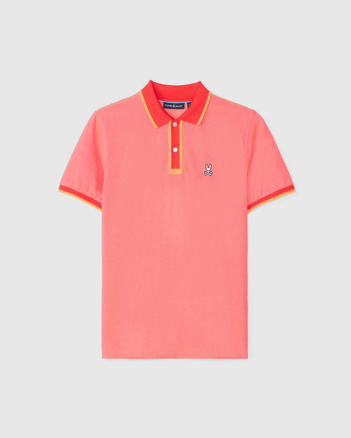 The Psycho Bunny MENS WOODWAY OXFORD POLO - B6K405C200 is a brightly colored short-sleeve polo shirt in coral pink with red and yellow trim on the collar and sleeves. Made from a soft Pima cotton-blend, it features a classic two-button placket and a small embroidered bunny logo on the left chest.