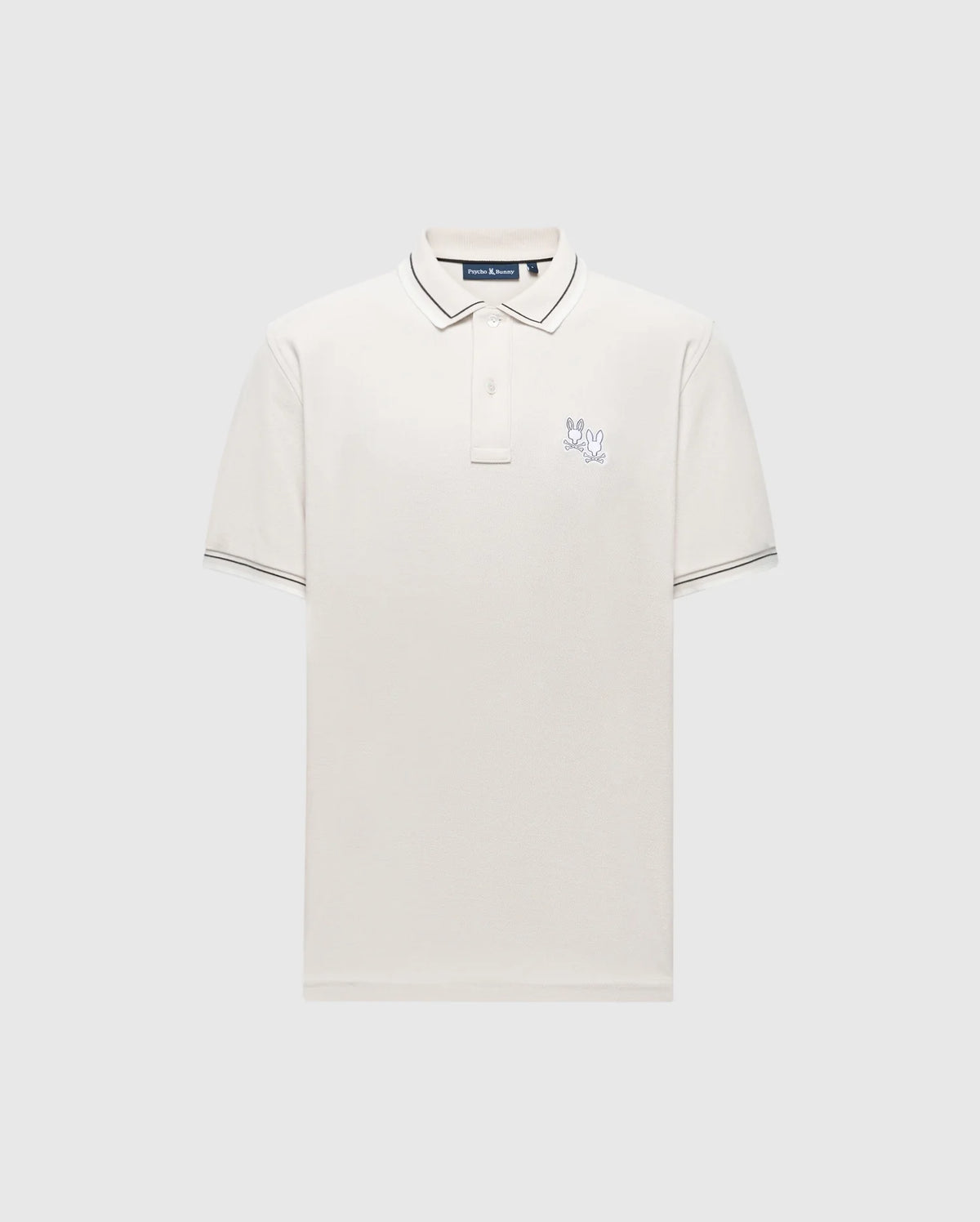 The Psycho Bunny MENS ELLIOT PIQUE POLO - B6K505F200 is a white Pima cotton shirt with short sleeves, featuring a collar, three buttons, subtle dark trim on the collar and sleeves, a small embroidered logo on the chest, all against a plain light gray background.