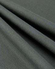 A close-up view of smooth, dark green Pima cotton with a fine, textured weave. The fabric is draped, creating gentle folds and shadows that highlight its soft and flexible nature, reminiscent of a luxurious Psycho Bunny MENS KINGSTON PIQUE POLO SHIRT - B6K764D200.
