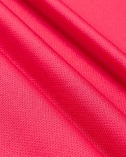 Close-up of vibrant pink satin fabric with a smooth and slightly textured surface, showcasing the material's glossy finish and delicate folds, reminiscent of the Psycho Bunny MENS BELLEVUE SPORT POLO SHIRT - B6K905D200 in its attention to detail.