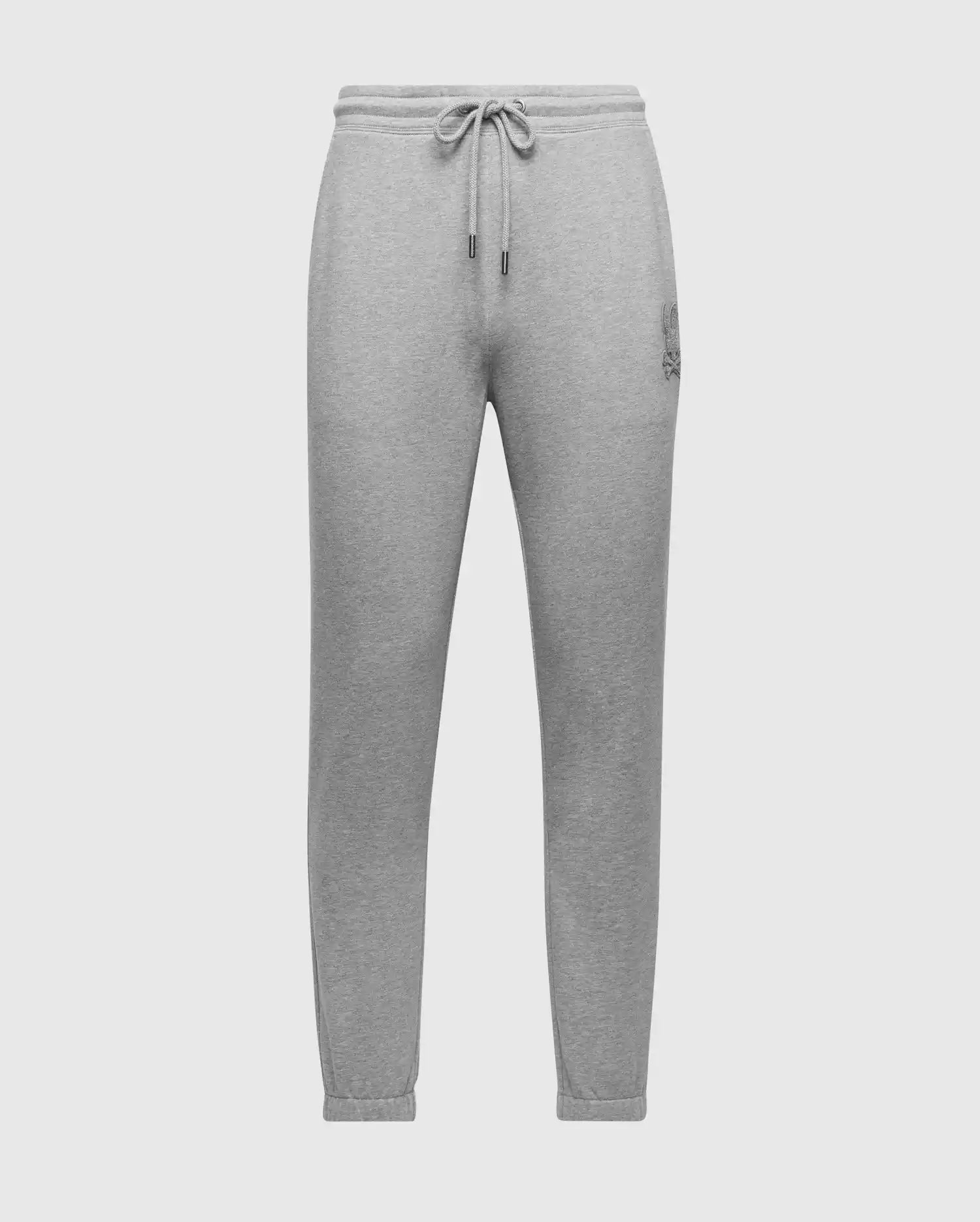 Introducing Psycho Bunny's MENS ELDORADO BRUSH BACK JOGGER - B6P285E200: gray sweatpants with an elastic waistband, ankle cuffs, and adjustable drawstring for ultimate comfort. Stylishly sleek, they feature a small embroidered logo on the upper left thigh against a white backdrop.