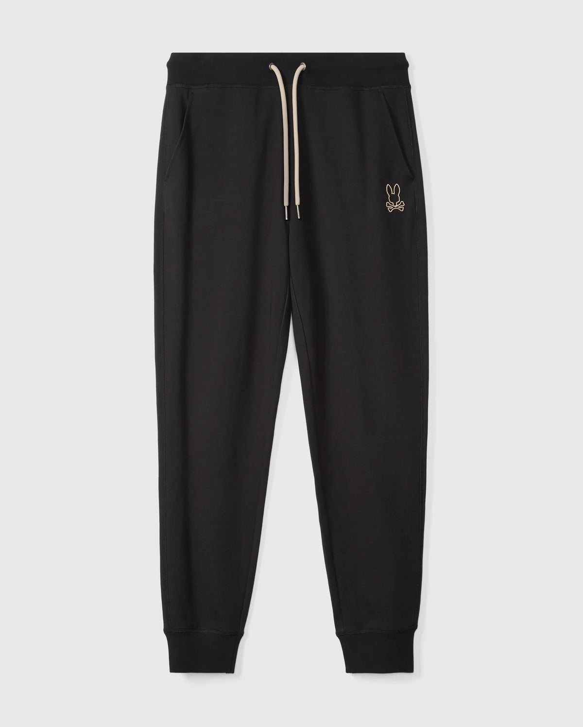 The MENS JAMES PREMIUM SWEATPANT (B6P791D200) by Psycho Bunny are black cotton-blend sweatpants featuring an elastic waistband and cream drawstring, with a small rabbit logo embroidered on the left side. Designed with a tapered fit and cuffs at the ankles, these premium sweatpants are displayed against a plain white background.