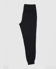 The Psycho Bunny MENS FRENCH TERRY KNIT SWEATPANTS - B6P828ARFT are men's black sweatpants in a classic fit, crafted from soft French terry fabric, shown side-on against a white background. They feature a convenient pocket and an elastic waistband for comfort and style.