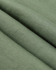 Close-up of green knitted fabric, highlighting its texture and soft appearance with visible weave patterns that evoke the cozy feel of Psycho Bunny's casual bottoms. The fabric is folded into gentle, evenly spaced ridges similar to the smooth drape of the MENS PACIFIC CHENILLE JOGGER - B6P972D200.