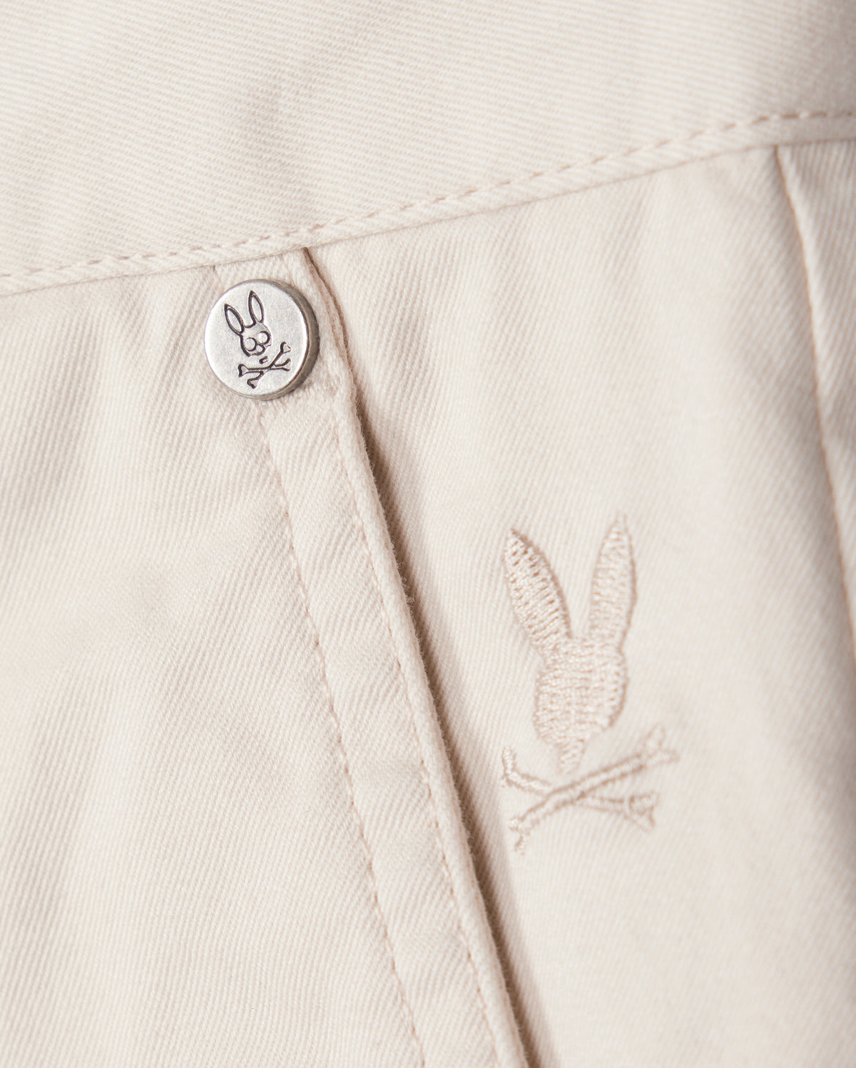 A button on a white shirt, perfect for pairing with Psycho Bunny's MENS YORK CHINO SHORT - B6R357B200.