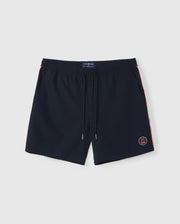 A pair of dark blue Psycho Bunny MENS SONTERRA STRIPE SPORT SHORT - B6R464C200 with an elastic waistband and drawstring, crafted from quick-drying stretch fabric. The shorts feature orange stripes along the sides and a small embroidered emblem near the bottom left hem, set against a plain white surface.