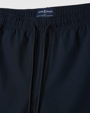 Close-up of a pair of dark blue men's sport shorts with an elastic waistband and drawstring. Made from quick-drying stretch fabric, the label reads "Psycho Bunny" at the back. These are the MENS SONTERRA STRIPE SPORT SHORT - B6R464C200 by Psycho Bunny.