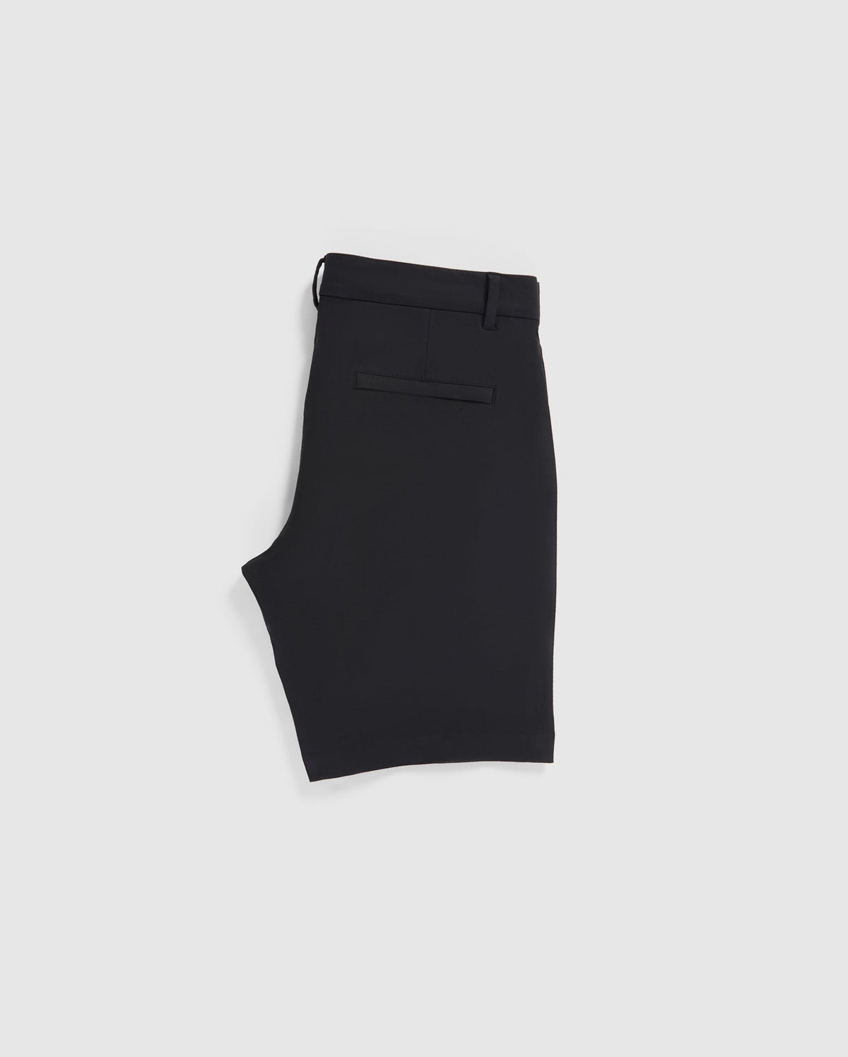 A pair of neatly folded Psycho Bunny MENS GABLE REGULAR FIT SPORT SHORT - B6R761ARCN made from a smooth, durable stretch cotton-nylon fabric is displayed on a plain white background. The black shorts feature belt loops, a hidden zip pocket, and a single welt pocket on the back.