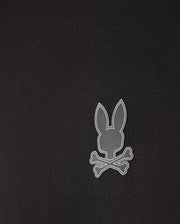 The men's Laurier 1/4 zip hoodie by Psycho Bunny in black features an off-center, small gray emblem of a bunny head above crossed bones. Its minimalist and modern design complements any athleisure look perfectly.