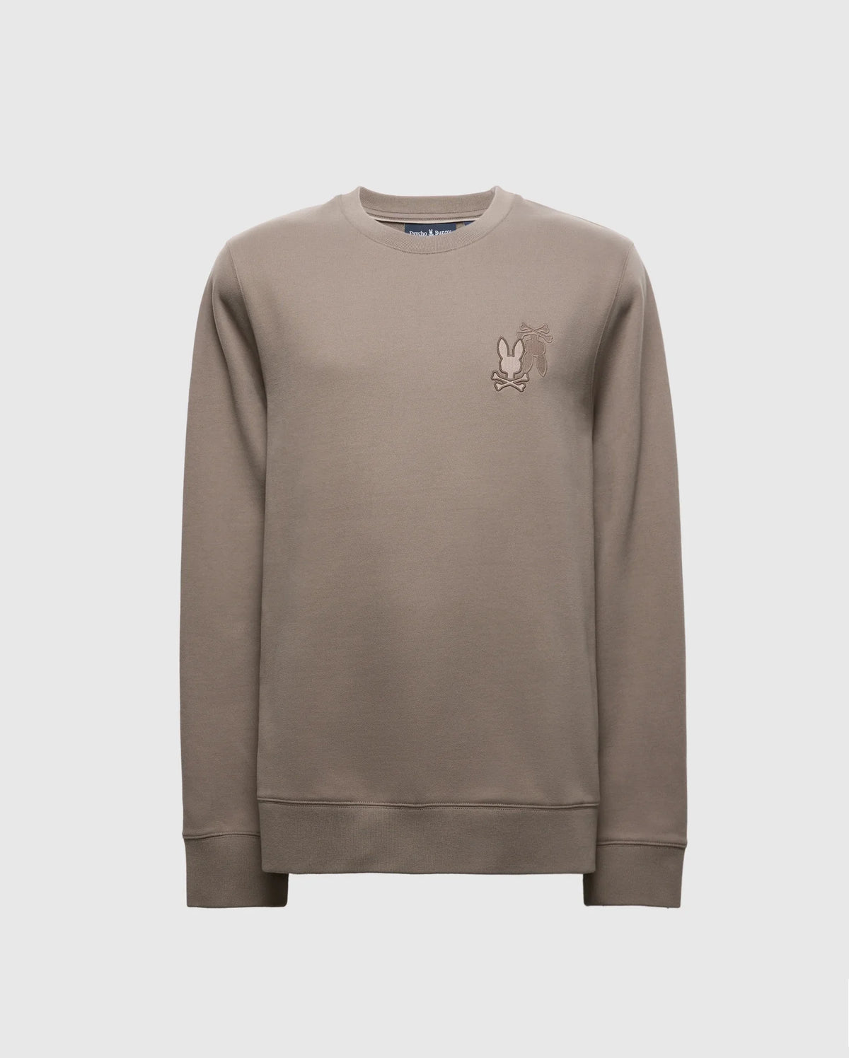 The Psycho Bunny MENS PIERCE PEACHED TERRY CREW - B6S278E200 sweatshirt in taupe features a small cartoon character embroidered on the upper left chest. Made from high-quality cotton, it includes ribbed cuffs, hem, and a classic crew neckline for a stylish appearance.