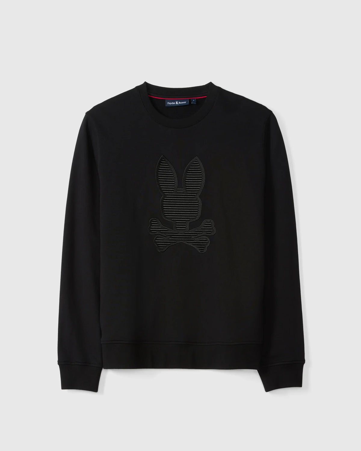 The Psycho Bunny Men's Kingston Sweatshirt (B6S480D200) is crafted from lush cotton jersey in black and showcases a striking 3D-embroidered rabbit head with crossed bones on the front. Complete with long sleeves and a crew neckline, the design stands out against its plain background.