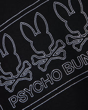 This MENS TACOMA MODAL SWEATSHIRT - B6S927D200 by Psycho Bunny is crafted from premium modal fabric and showcases a striking black design. It features three white embroidered bunny skull motifs with crossbones, along with the "PSYCHO BUNNY" name stitched in white beneath, providing luxurious comfort and a unique style.