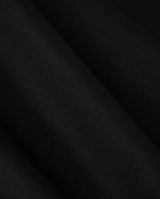 A close-up image showcasing the luxurious comfort of the Psycho Bunny MENS TACOMA MODAL SWEATSHIRT - B6S927D200, featuring a smooth, dark black premium modal fabric with subtle texture and folds that create gentle shadows on its surface.