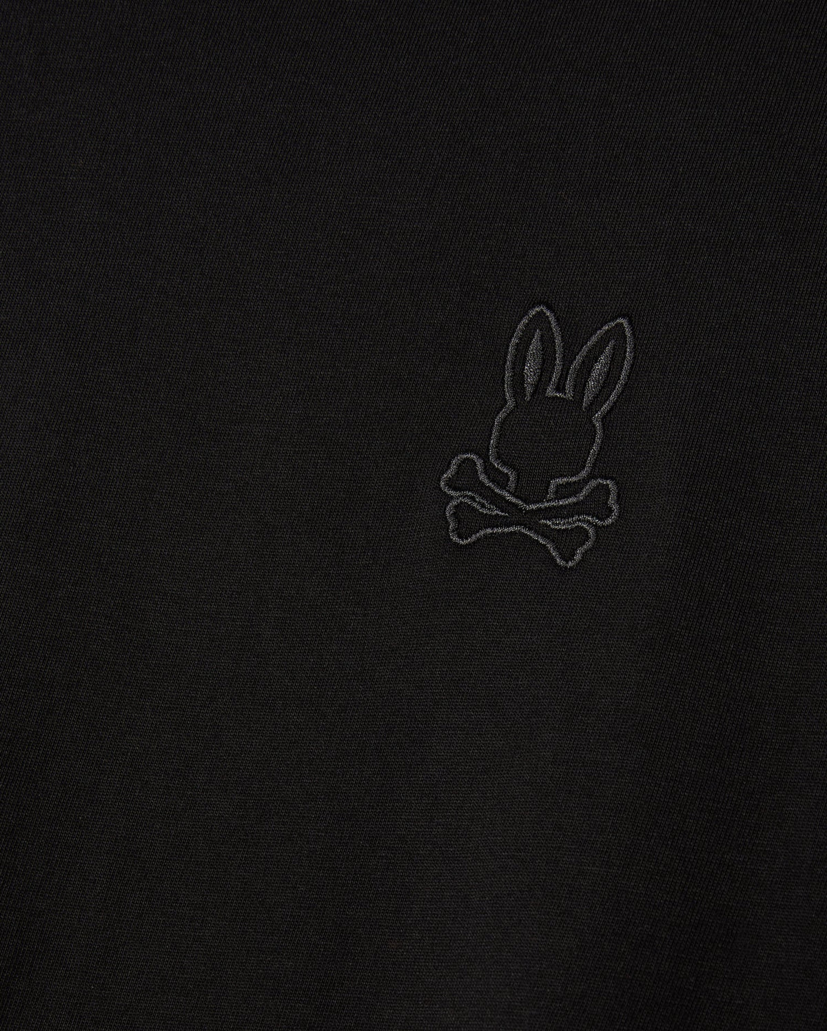 Introducing the MENS ALBERTON LONG SLEEVE TEE - B6T867D200 by Psycho Bunny, featuring a detailed embroidered design of a bunny with crossed bones beneath. This black fabric tee is crafted from premium Pima cotton, delivering both a stylish appearance and luxurious comfort.