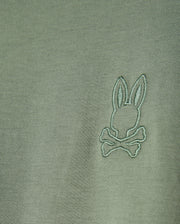 The MENS ALBERTON LONG SLEEVE TEE - B6T867D200 by Psycho Bunny is a fashion masterpiece, crafted from olive green Pima cotton and featuring an embroidered logo with a stylized rabbit head above crossed bones.