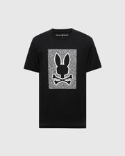 The Psycho Bunny MENS ROCKTON GRAPHIC TEE - B6U247C200 is a black T-shirt made from soft, 100% Pima cotton. It features a white geometric pattern with a bunny head and crossbones in the center with static-like texture, and "Psycho Bunny" text on the collar, crafted in Peru for top quality and comfort.