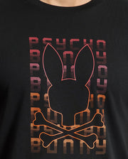 The MENS CORTES GRAPHIC TEE - B6U328E200 by Psycho Bunny features a lightweight design crafted from premium men's Pima cotton. It displays a striking black graphic of a bunny face with crossbones, highlighted with red and orange outlines. The backdrop showcases the word "PSYCHO" repeated vertically in a captivating purple-to-orange gradient, enhancing the bold allure of this stylish men's tee.
