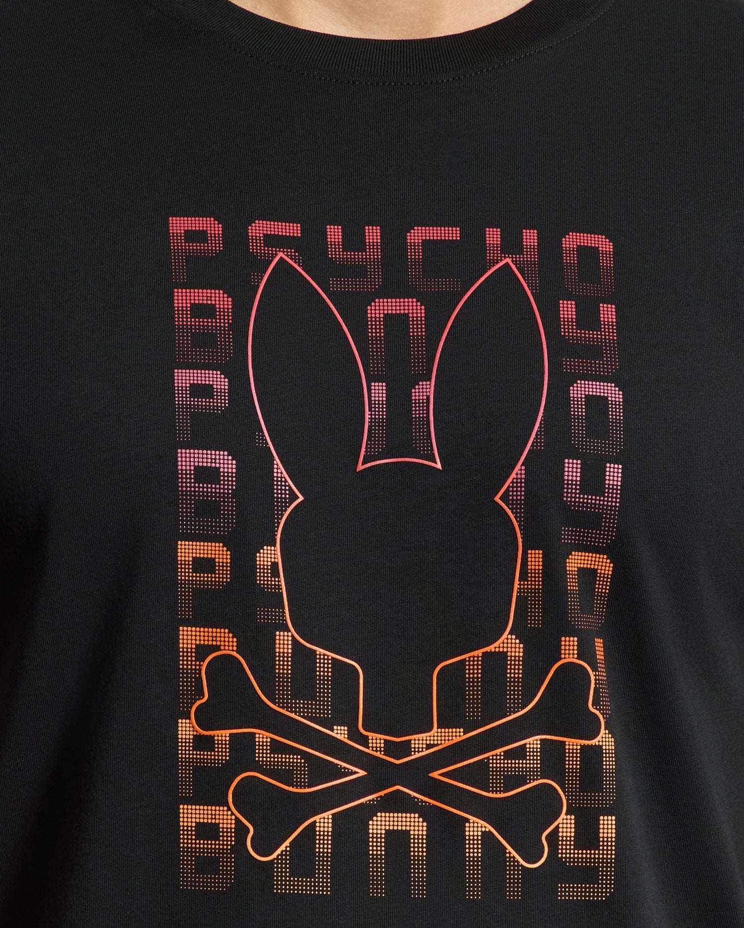 The MENS CORTES GRAPHIC TEE - B6U328E200 by Psycho Bunny features a lightweight design crafted from premium men's Pima cotton. It displays a striking black graphic of a bunny face with crossbones, highlighted with red and orange outlines. The backdrop showcases the word "PSYCHO" repeated vertically in a captivating purple-to-orange gradient, enhancing the bold allure of this stylish men's tee.