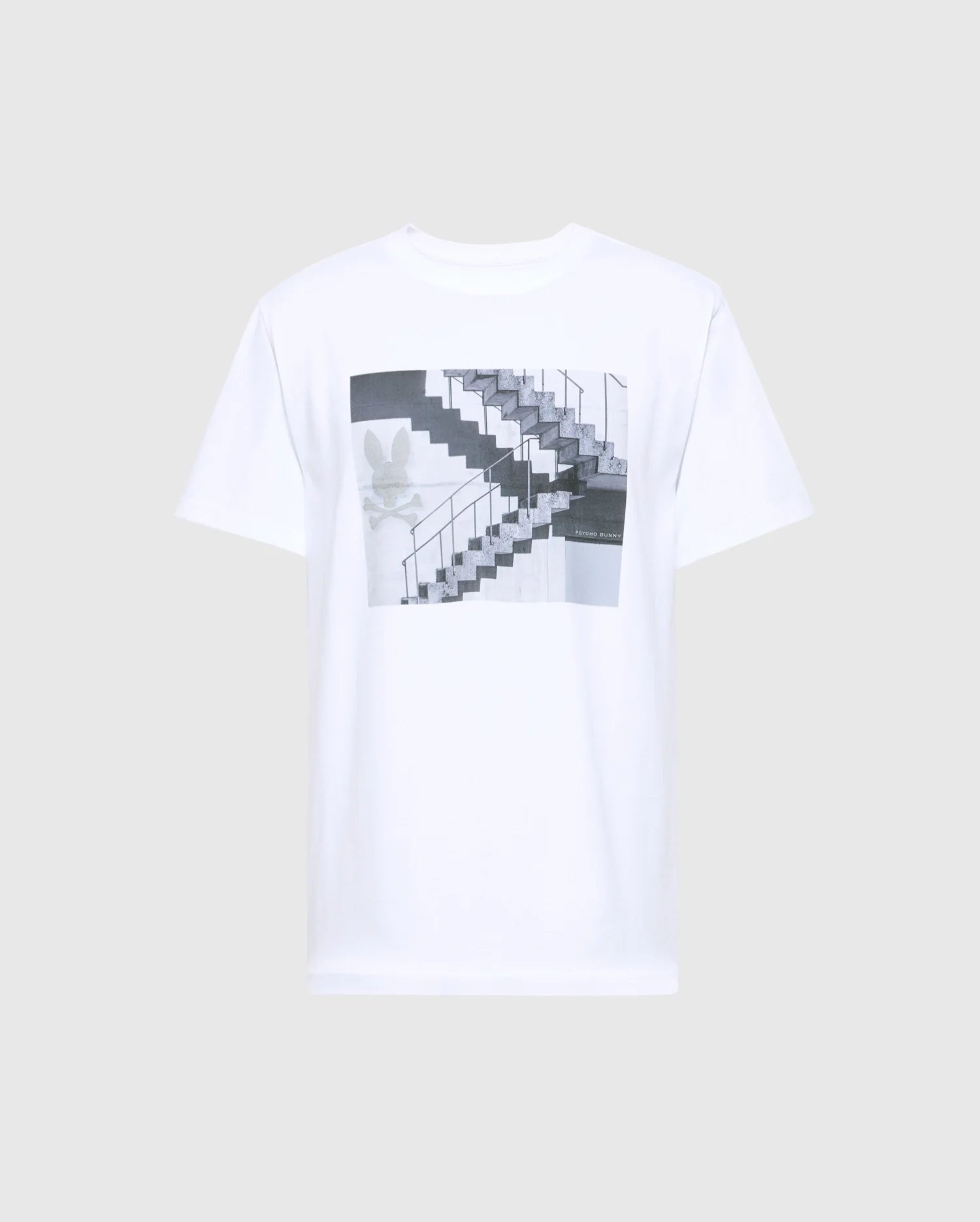 Psycho Bunny's MENS DEAN PHOTO REAL TEE - B6U390E200 is a white Pima cotton T-shirt featuring an urban geometric print of a black and white staircase with handrails, accented by a subtle floral design on the left side.