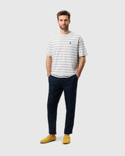 Head to toe view of a male model wearing the mens alton stripe heavy weight tee in pearl with both hands in his pockets