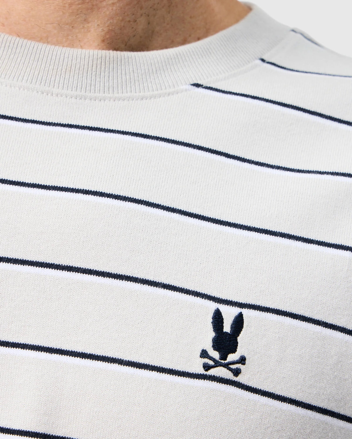 A close up of the mens pima cotton alton stripe heavy weight tee featuring black stripes and a black brand logo