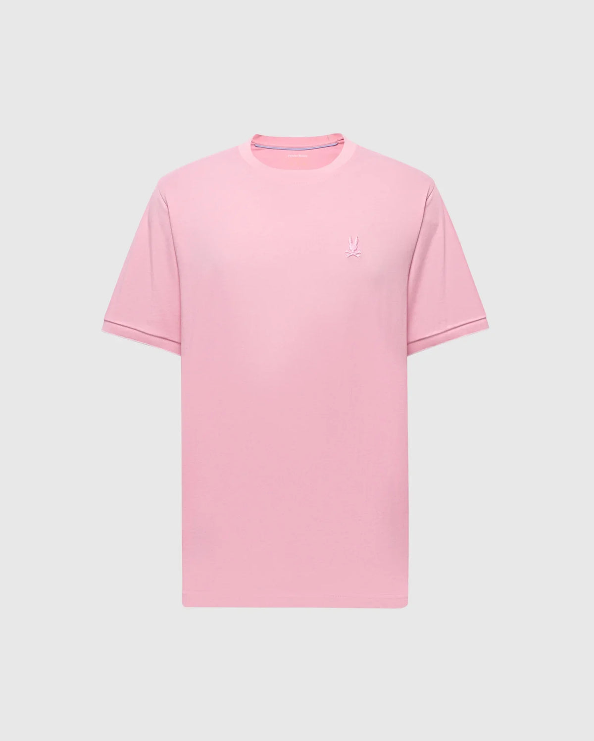 The MENS BRYCE PERFORMANCE TEE - B6U490F200 by Psycho Bunny features a plain pink design with short sleeves and a crew neck, made from a Modal-Pima cotton blend. A small embroidered logo is on the left chest, set against a light gray background.