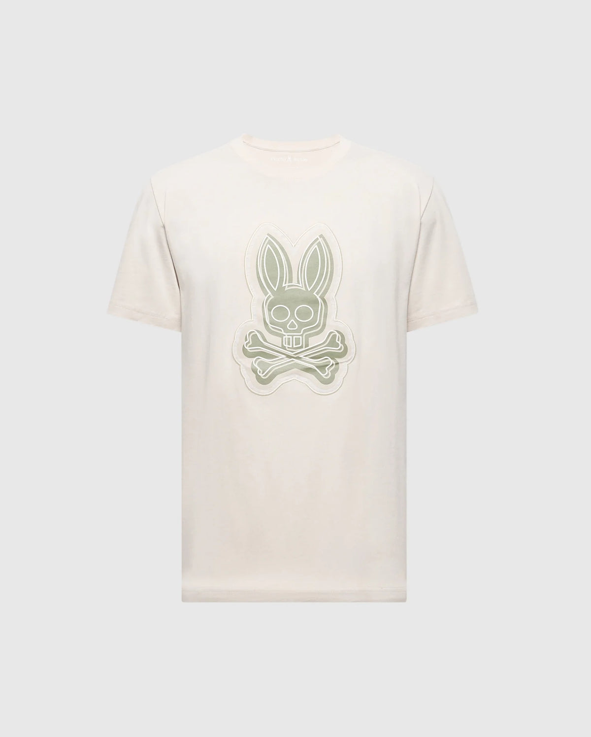 The MENS SYDNEY GRAPHIC TEE by Psycho Bunny features a cream-colored Pima cotton design with a stylized gray bunny and crossed bones logo on the front, set against a light gray background.
