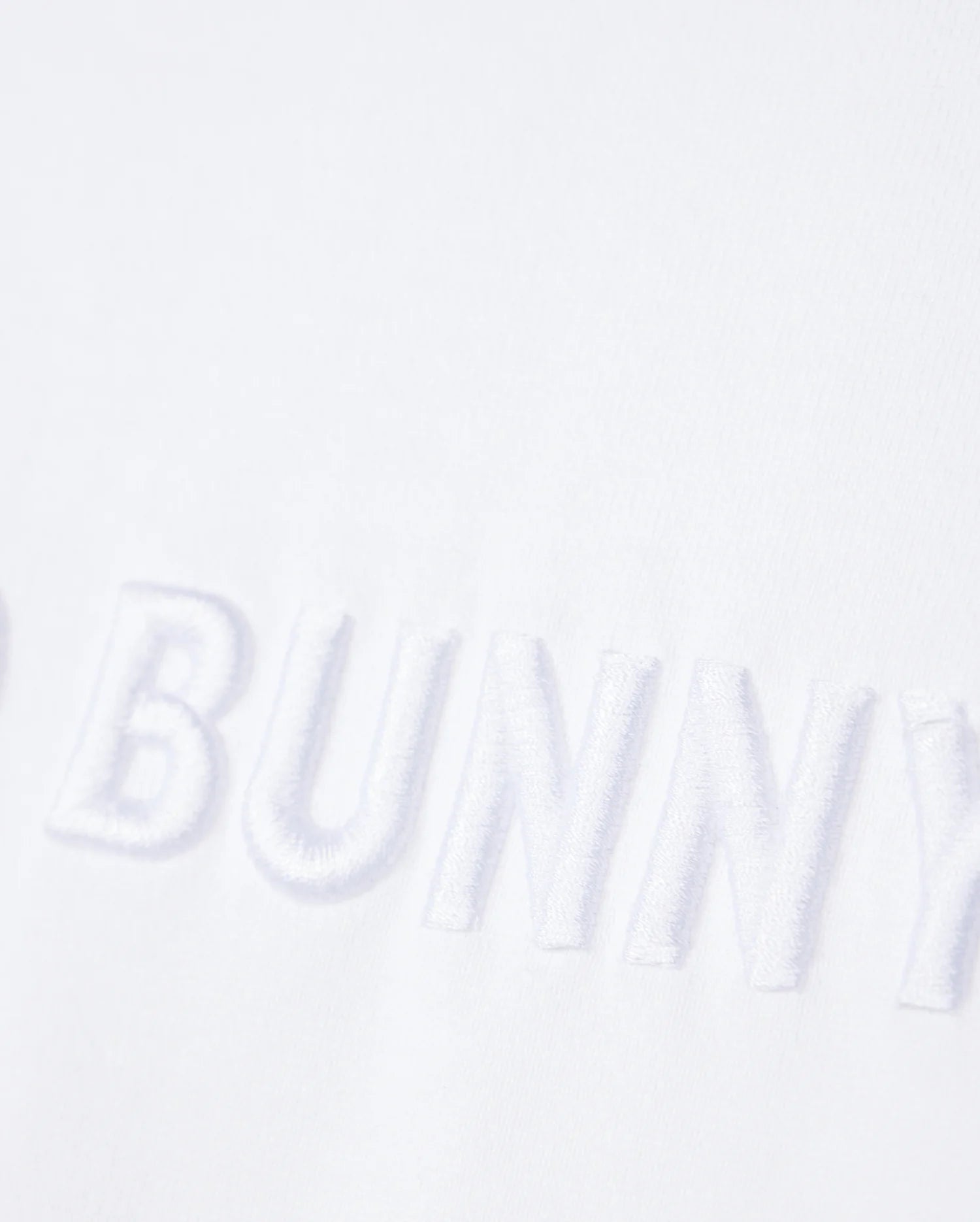 close up of front wordmark graphic of the pima cotton windcrest heavy weight tee in white