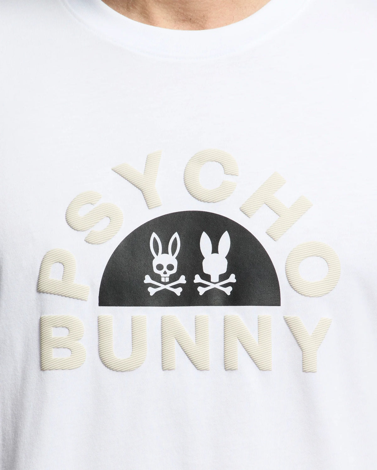 The Men's Goldie Graphic Tee - B6U606F200 by Psycho Bunny is crafted from soft Pima cotton and features the bold "PSYCHO BUNNY" text with a black stylized bunny skull and crossbones graphic between the words.