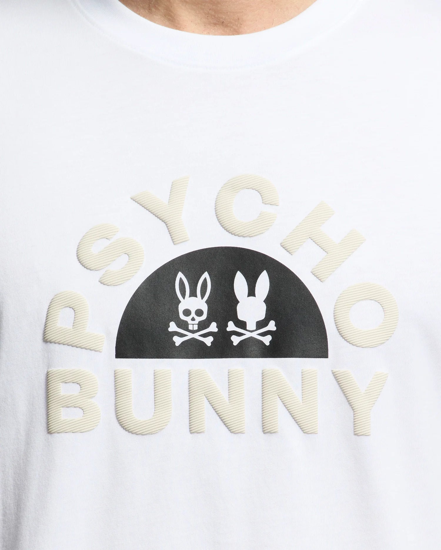 The Men's Goldie Graphic Tee - B6U606F200 by Psycho Bunny is crafted from soft Pima cotton and features the bold "PSYCHO BUNNY" text with a black stylized bunny skull and crossbones graphic between the words.