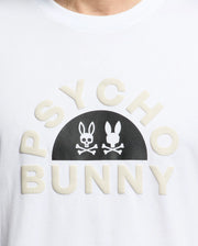 The Men's Goldie Graphic Tee - B6U606F200 by Psycho Bunny is crafted from soft Pima cotton and features the bold "PSYCHO BUNNY" text with a black stylized bunny skull and crossbones graphic between the words.