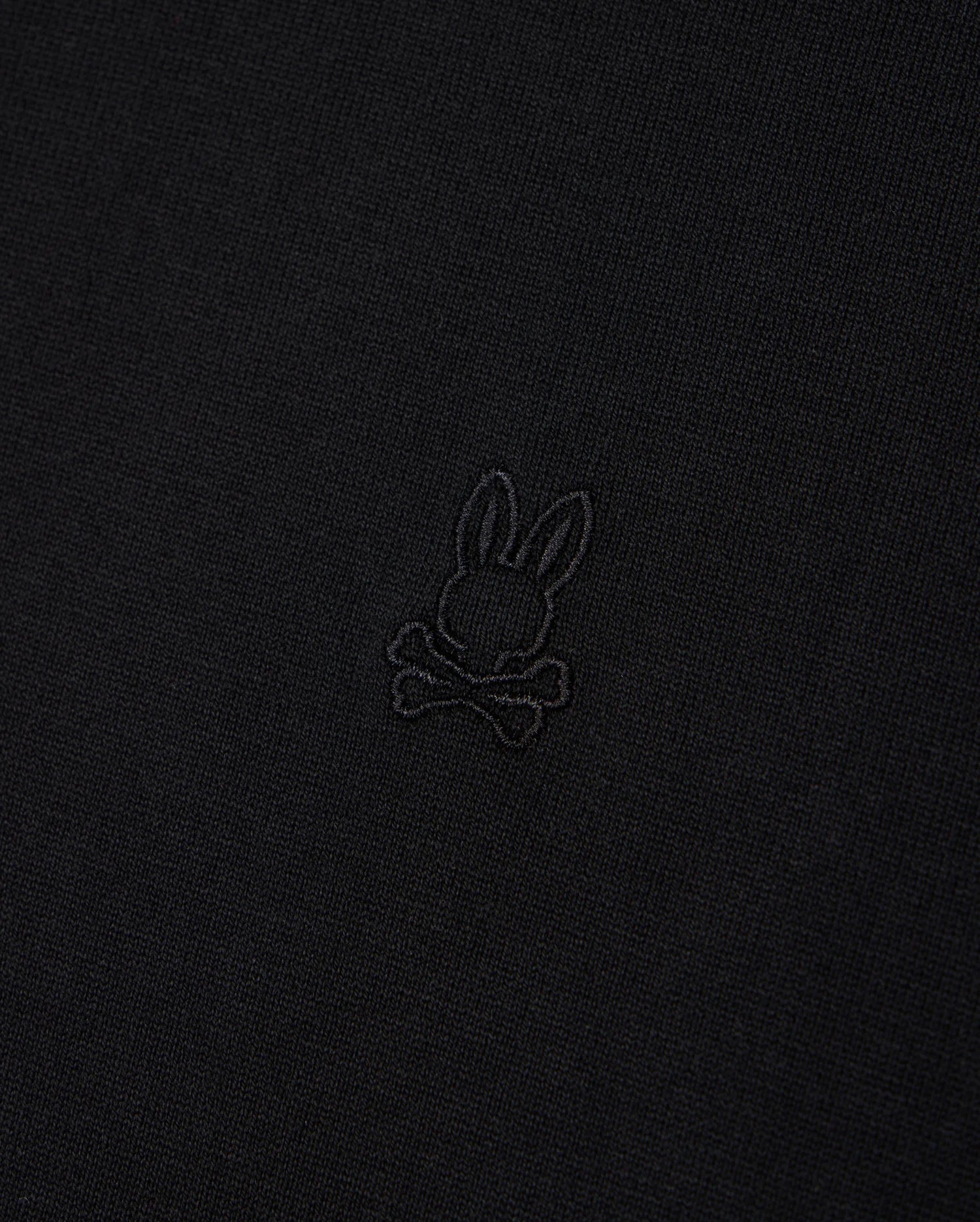 The Psycho Bunny MENS DUKE OVERSIZED TEE - B6U742D200 is a relaxed fit Pima cotton tee in black, featuring a small embroidered emblem of a rabbit's head with crossbones underneath in matching black thread.