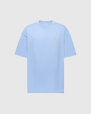 The Psycho Bunny MENS DUKE OVERSIZED TEE (B6U742D200) is a light blue heavyweight jersey T-shirt with a relaxed fit. It features short sleeves and a subtle embroidered design on the left chest, displayed on a plain white background.