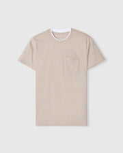 The Psycho Bunny MENS CAMPO POCKET TEE - B6U801D200 is a beige pima cotton shirt with a white crew neck and an embroidered logo on its left-side pocket, set against a light gray background.