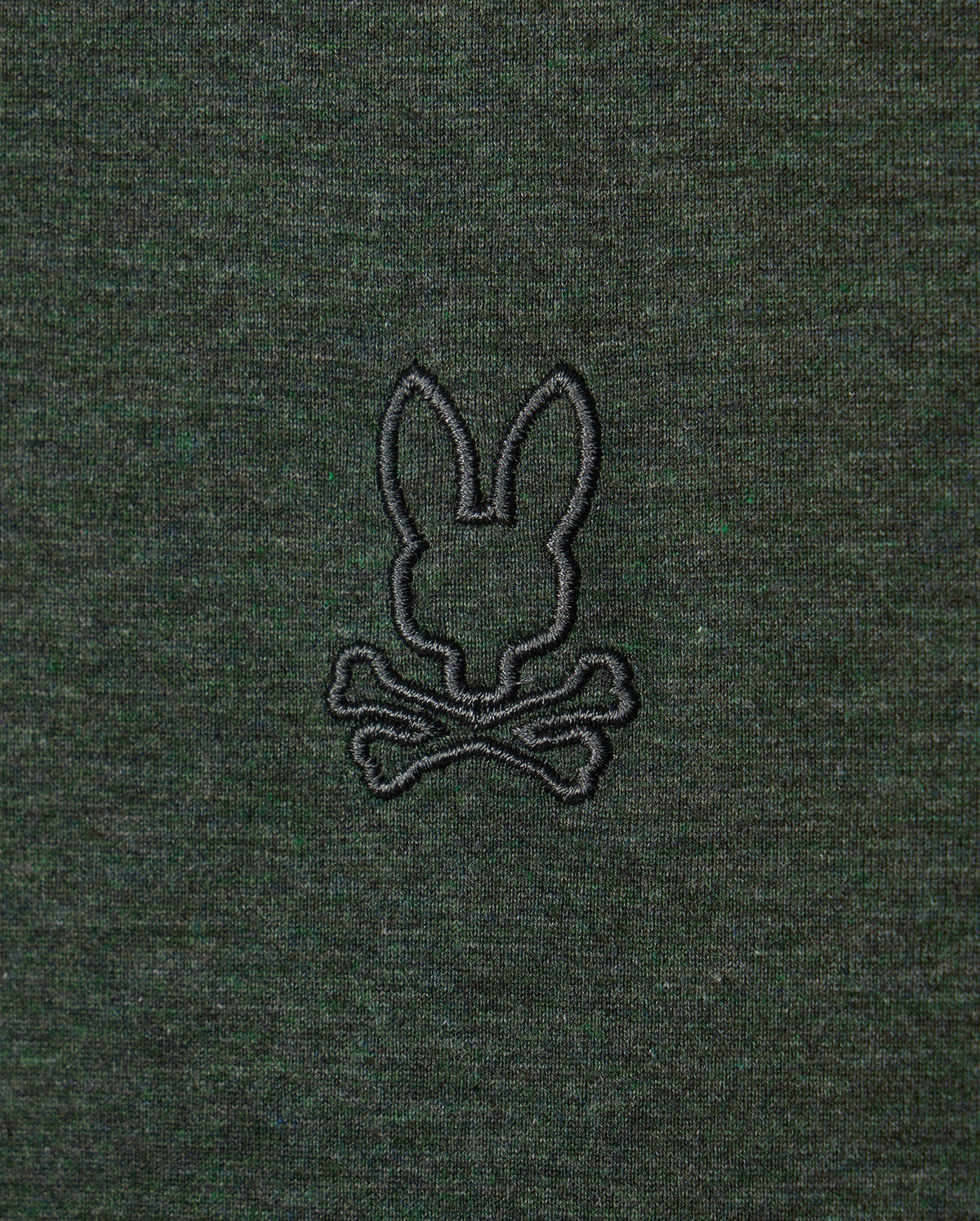 The MENS JAMES PREMIUM CREW NECK TEE - B6U952D200 by Psycho Bunny is made from high-quality Pima cotton and showcases a sophisticated dark green fabric. It features a tonal outline of their signature bunny, embroidered in black above two crossed bones, reminiscent of a skull and crossbones motif.
