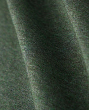 Close-up of a Psycho Bunny MENS JAMES PREMIUM CREW NECK TEE - B6U952D200, crafted from premium Pima cotton in green. The fabric showcases a soft texture with a subtle diagonal pattern, appearing smooth and gently draped. It highlights the tonal outline bunny embroidered into the weave along with its natural folds.