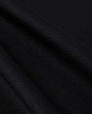 Close-up photo of textured Psycho Bunny Peruvian Pima cotton fabric, showcasing the fine weave and detail of the material.