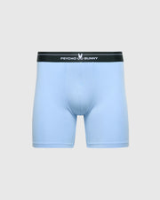 These light blue boxer briefs, part of the Psycho Bunny MENS 2 PACK BOXER BRIEF - B6V481F200, have a black waistband with the "Psycho Bunny" name and bunny logo in white. Made from breathable Stretch Pima cotton, they ensure comfort against a plain gray background.