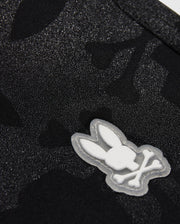 Close-up of a textured black fabric with a subtle pattern, featuring a white Playboy bunny logo appliqué on Psycho Bunny MENS MALTA HYDROCHROMIC SWIM TRUNK - B6W321B2SW.