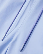Close-up image of the Psycho Bunny MENS MELVIN SWIM TRUNK - B6W665C200 in light blue with purple drawstrings. The drawstrings feature shiny silver metal tips, and the quick-dry textile appears smooth and slightly glossy. The image emphasizes the details and texture of the material and drawstrings.